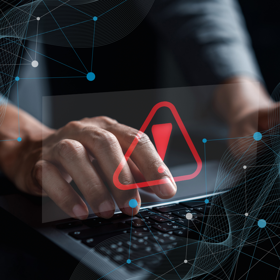 The picture shows a risk or warning sign over something typing on a PC.